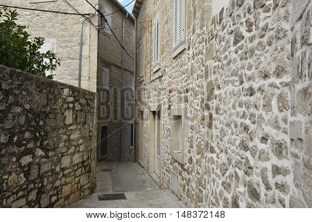 Little narrow streer in the town Supetar on Brac island in Croatia.