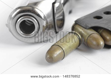 Pistol and ammunition on the white background.