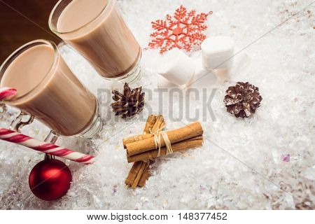 Overhead view of composite image of hot chocolates on table in fake snow