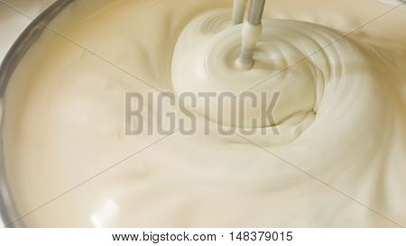 close up of twist white cream spiining in the blow