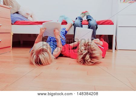 kids pretend doing homework at home by fooling around