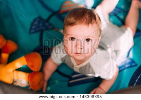 Cute Little Baby Boy Playing In Colorful Playpen, Indoors. Beautiful Child Having Fun At Nursery.