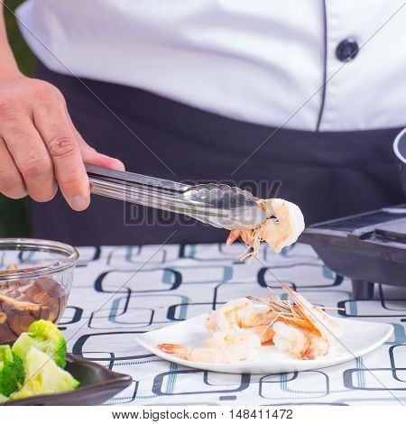 Chef lift cookng shrimp to plate / Stir fry Broccoli concept