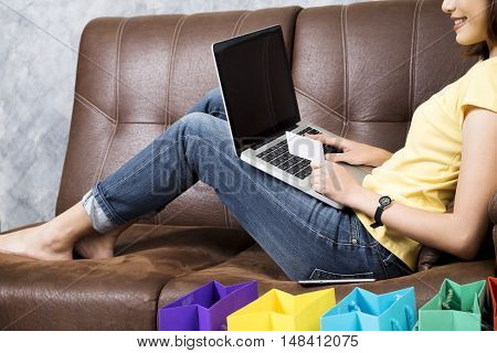 Asia Woman Shopping Online At Home. Searching Product In Shopping Website And Pay By Credit Card.