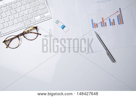 View From Above Of Office Supplies On A White Working Table Background.