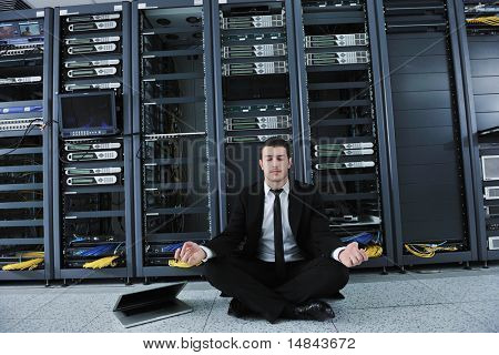giovane bello business man in black vestito e cravatta pratica di yoga e relax al network server camera whi