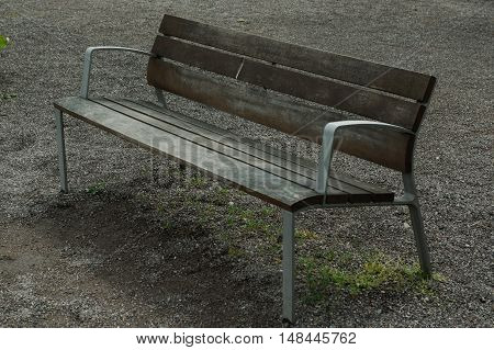 a brown lonely wooden bench in the park