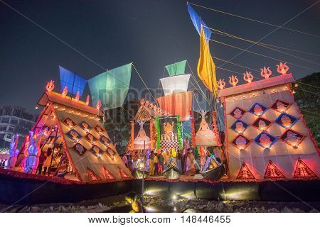 KOLKATA INDIA - OCTOBER 21 2015 : Beautiful exterior of decorated Durga Puja pandal at night Howrah West Bengal India. Shot under colored lights. Durga Puja is biggest religious festival of Hinduism.