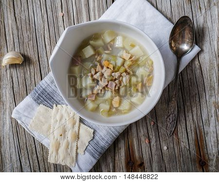 Rhode Island Clam Chowder Soup on Wood Background, top view.