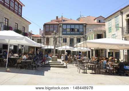 PONTEVEDRA, SPAIN - AUGUST 6, 2016: People at outdoor bars in Plaza of Stone in the city of Pontevedra Galicia Spain.