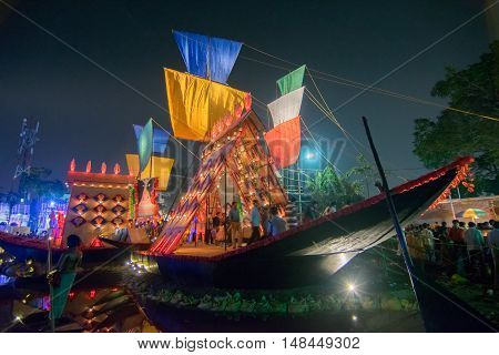 KOLKATA INDIA - OCTOBER 21 2015 : Beautiful exterior of decorated Durga Puja pandal at night Howrah West Bengal India. Shot under colored lights. Durga Puja is biggest religious festival of Hinduism.