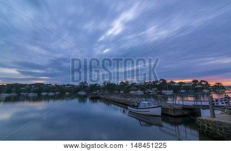 Dawn on the river Fal in Cornwall, England - long exposure, with a boat moored in the forefront of the frame