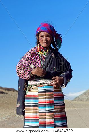 NGARI PREFECTURE, TIBET - MAY 7, 2013: Tibetan woman on the trail around sacred mount Kailash in Ngari Prefecture, Tibet Autonomus Region of China.