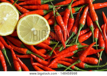 sour sliced lemon lay on a lot chilis