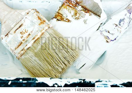 used paint brushes with a lot of white colour