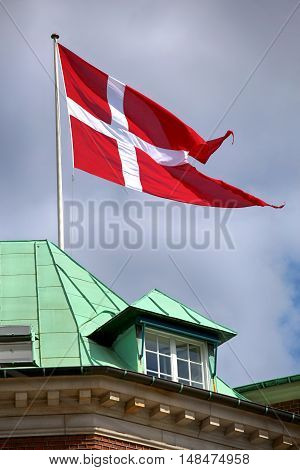 Waving Danish flag on the mast in Copenhagen Denmark