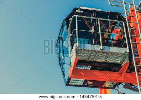 Cockpit of modern crane industry detail. Blue sky background