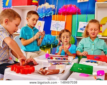 Group children boy and girl mold from plasticine in primary school. Plasticine lesson in primary school.