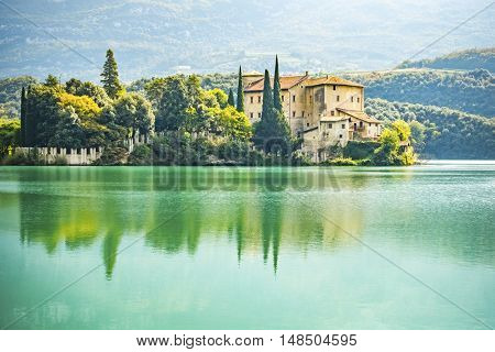 An image of the beautiful Castel Toblino in Italy in the morning light