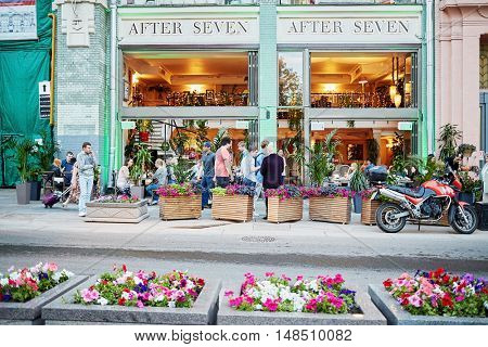RUSSIA, MOSCOW - JUN 22, 2015: People against facade of After Seven restaurant at Bolshaya Dmitrovka street. Restaurant After Seven - European restaurant with terrace.