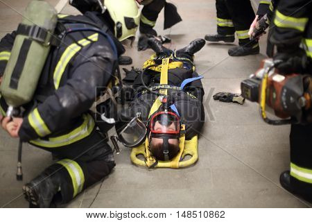 RUSSIA, MOSCOW - FEB, 26 2015: Firefighters in uniform are training to help suffer at Preobrazhenskaya ploshchad subway, focus on belt.