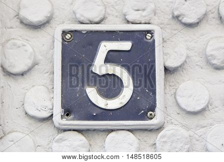 Number Five On The Wall Of A House