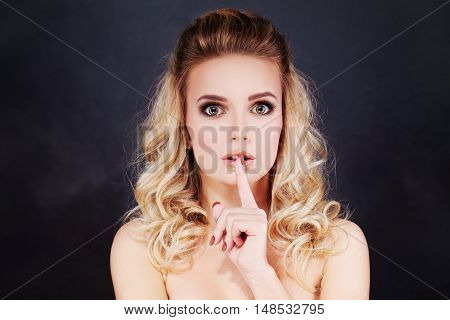 Sexy Woman Holding her Finger to her Lips. Gesture for Silence and Shushing