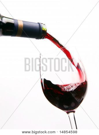 Red Wine Splashes into Stemmed Serving Glass