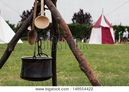 Black Pettle And Wooden Spoon After Bonfire On Tripod
