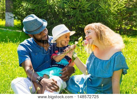 African American happy family: black father mom and baby boy on nature. Use it for a child parenting or love concept