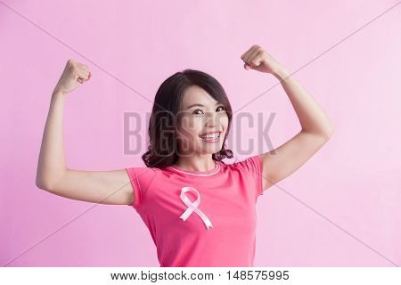 Happy Woman with pink ribbon and show strong biceps great for prevention breast cancer concept