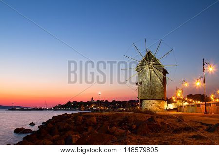 Mill in Nesebar at morning, colorful sunrise, Bulgaria