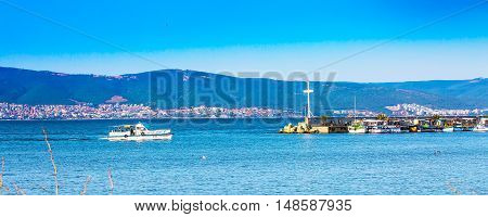 Nessebar, Bulgaria - July 25, 2016: Cross, port and boats and Sunny beach houses panorama in Nesebar, Black sea