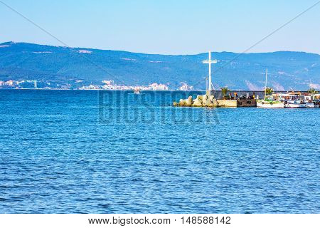 Nessebar, Bulgaria - July 25, 2016: Cross, port and boats view in Nesebar in Bulgaria