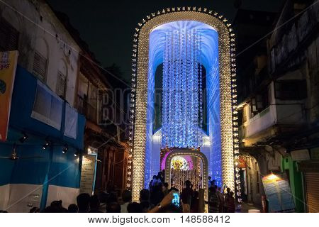KOLKATA INDIA - OCTOBER 18 2015 : Night image of decorated Durga Puja pandal shot at colored light at Kolkata West Bengal India. Durga Puja is biggest religious festival of Hinduism.