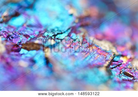Bornite ore crystallizes mineral its blurred natural background. Macro. Focus on the central. Very shallow depth of field