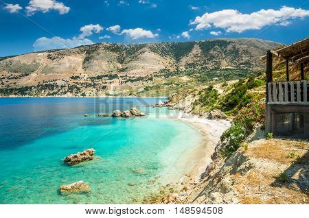 Vouti beach, Kefalonia island, Greece. People relaxing at the beach. The beach is surrounded by flowers.