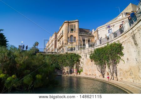 SYRACUSE, ITALY - SEPTEMBER 14, 2015: The Arethusa's fountain on the island of Ortygia in Syracuse, Sicily, Italy.