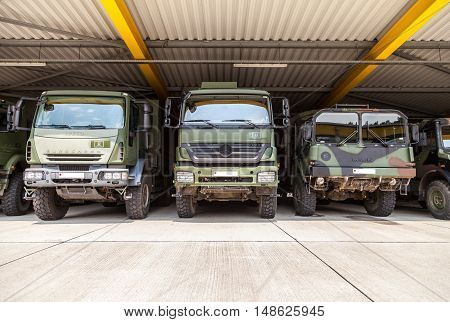 BURG / GERMANY - JUNE 25 : german military trucks stands under military roof on open day in barrack burg / germany at june 25 2016.
