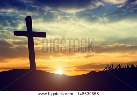 cross silhouette on the mountain at sunset