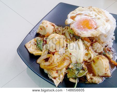Stir Fried Mixed Vegetables With Roasted Chili Paste , Fried Egg & Thai Jasmine Rice On Black Dish.