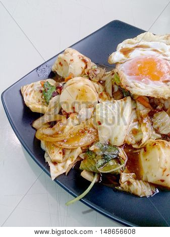 Stir Fried Mixed Vegetables With Roasted Chili Paste , Fried Egg & Thai Jasmine Rice On Black Dish.