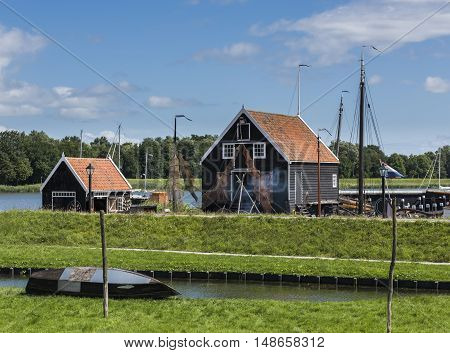 Enkhuizen The Netherlands - August 9 2016: Zuiderzee Museum Enkhuizen with old fisherman house fishing gear and boat in The Netherlands.