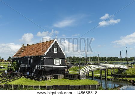 Enkhuizen The Netherlands - August 9 2016: Zuiderzee Museum Enkhuizen with old fisherman house and white bridge in The Netherlands.