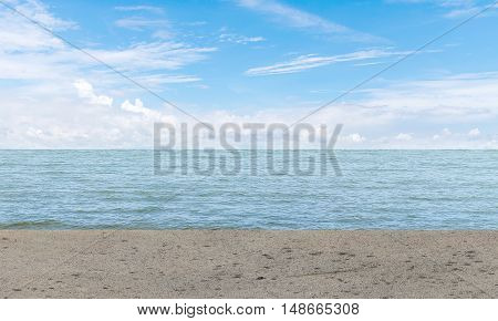 empty gray concrete floor beside sea with blue sky background. summer relaxing time.