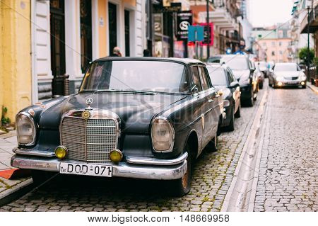 Batumi, Georgia - May 28, 2016: The Black Rarity Retro Mercedes Benz Car Parked On The Narrow Paved Street In A Row With Another Modern Automobiles In Summer Daytime.