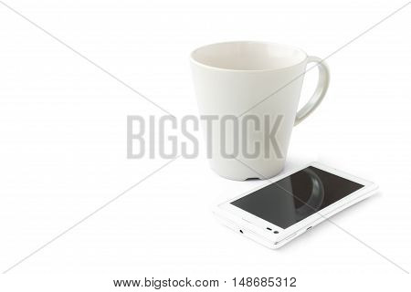 Smart phone and empty mug on white background Morning breakfast and technology concept