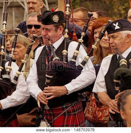 MOSCOW, RUSSIA - September 4, 2016: Pipers of Celtic pipes and drums band surrounded by townspeople in the Park of arts 