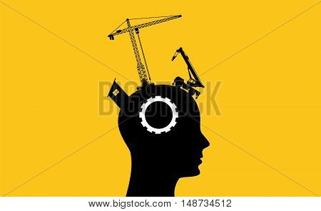 brain intelligence development concept with sillhouette human head and construction tools