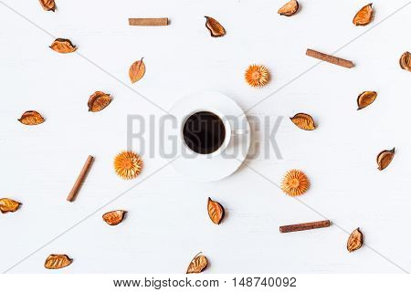 Autumn composition. Fall. Cup of coffee with autumn leaves, cinnamon sticks.  Top view, flat lay